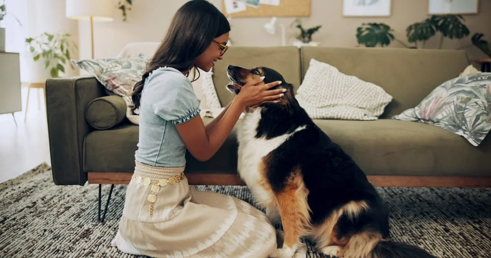 Woman sitting on the ground with her dog